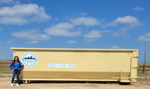 30 yard dumpster with a person beside it for scale