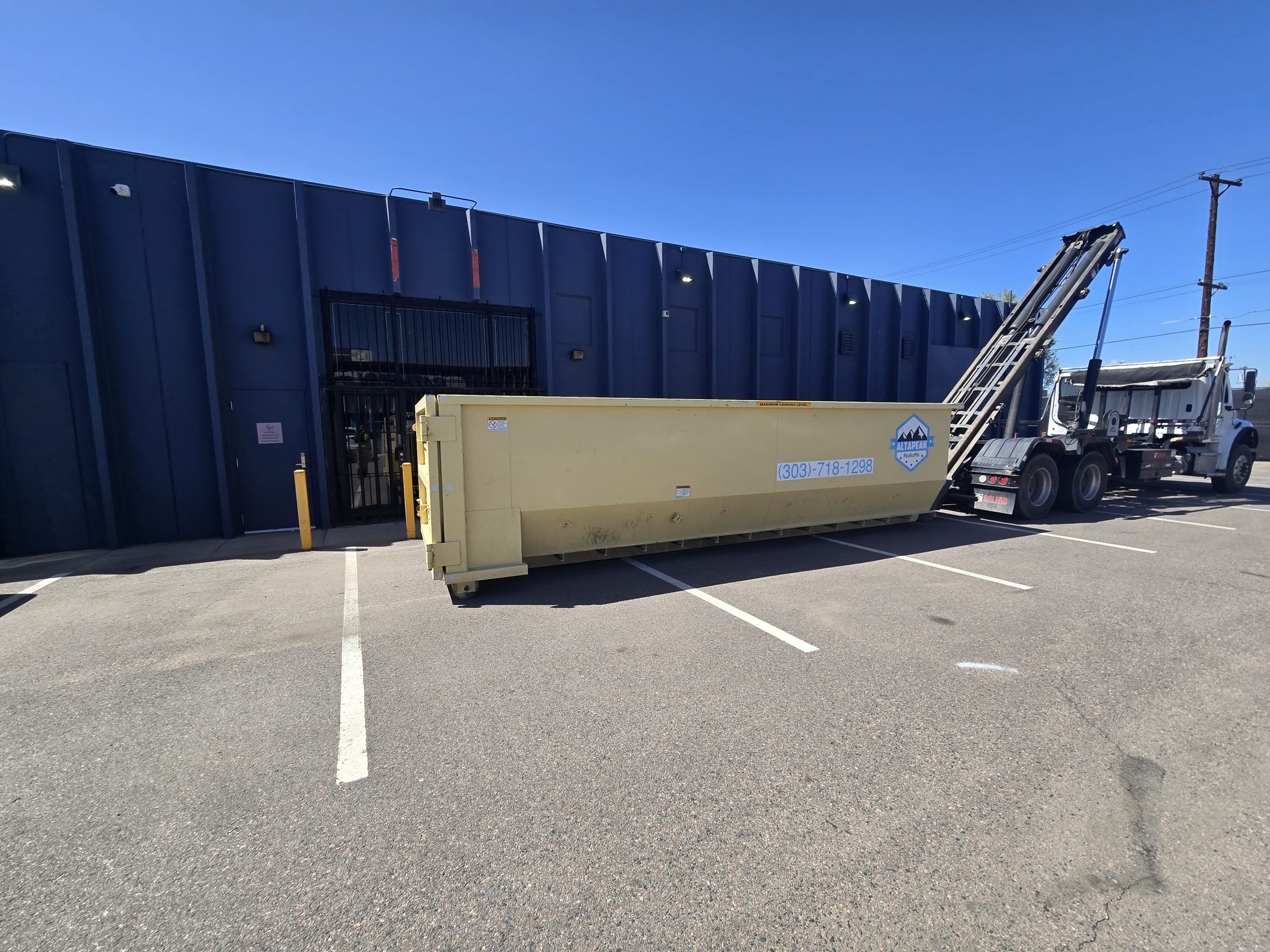 30 yard roll off dumpster being delivered to a commercial site