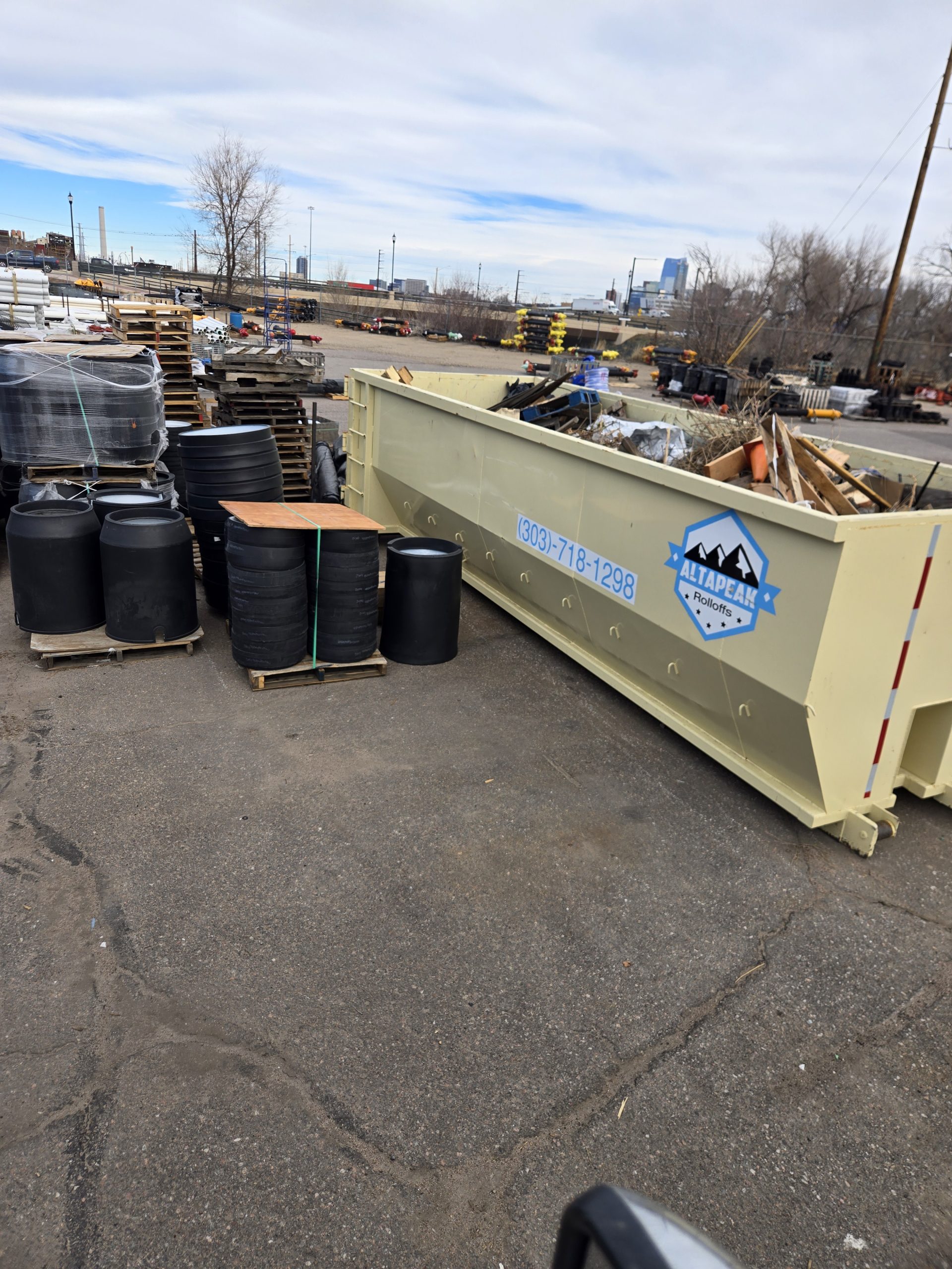 30 yard roll off dumpster loaded with mixed debris