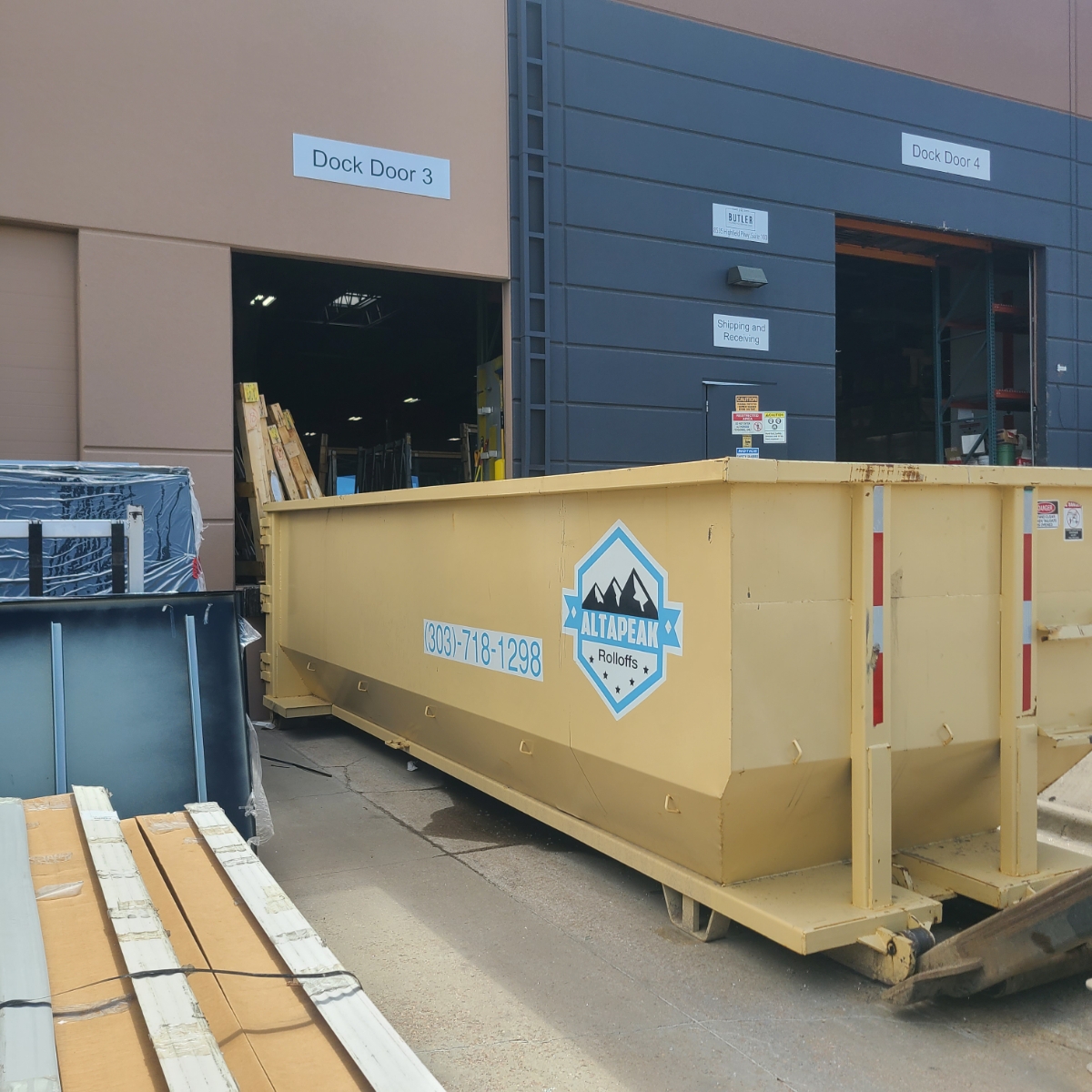 30 yard roll off dumpster beside a commercial loading dock